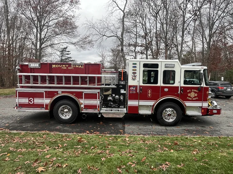Driver-side profile with open compartments showing tools and shelf storage