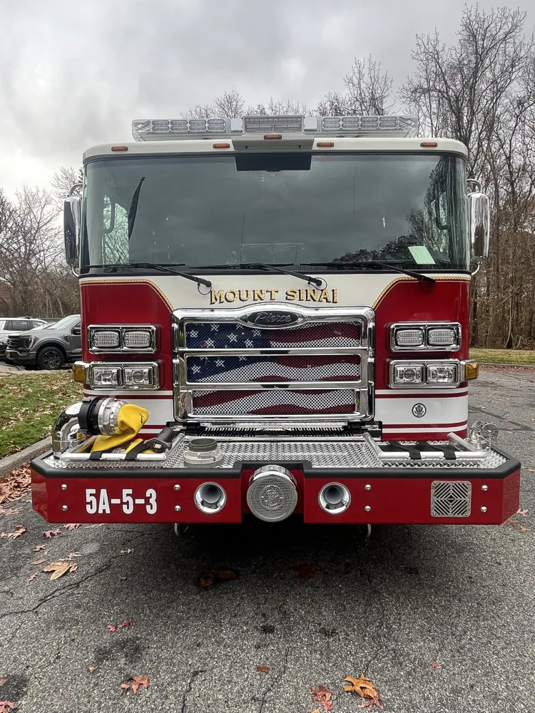 Head-on front view showing grille, bumper intake, and warning lights