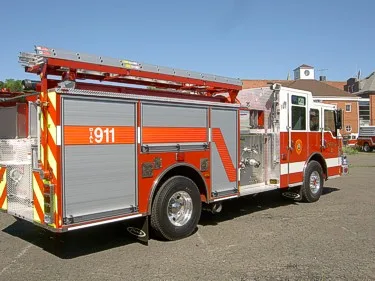 Rear-right exterior view showing side hosebed rails and rear body panel