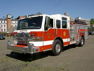 Front-left exterior view showing bumper, grille, and side body