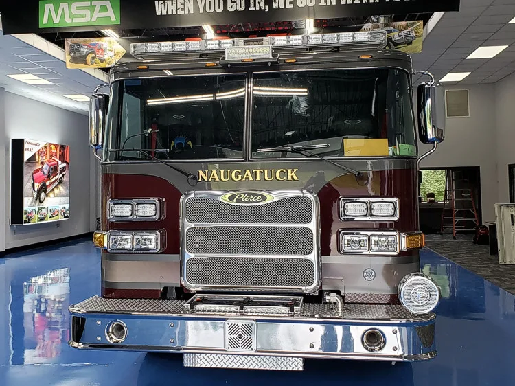Head-on front view showing grille, bumper, and warning lights