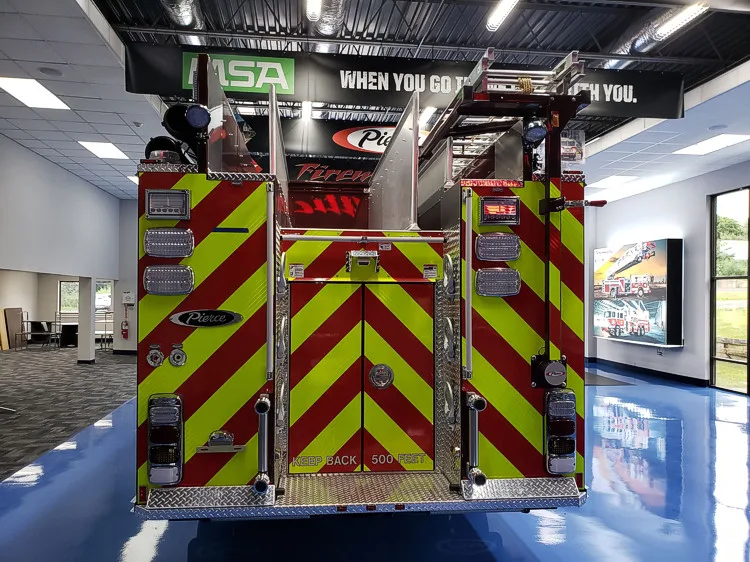 Rear view showing red-and-yellow chevrons and upper hosebed opening