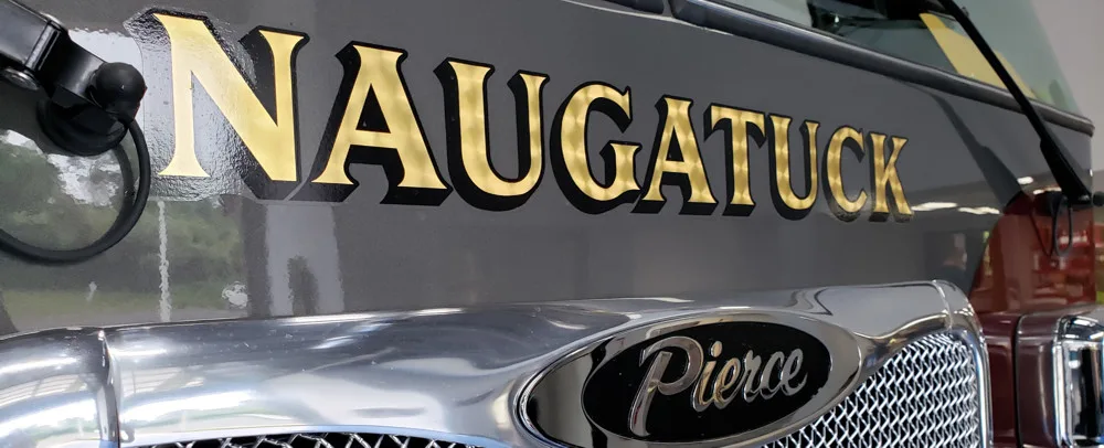 Front grille close-up strip showing Naugatuck lettering