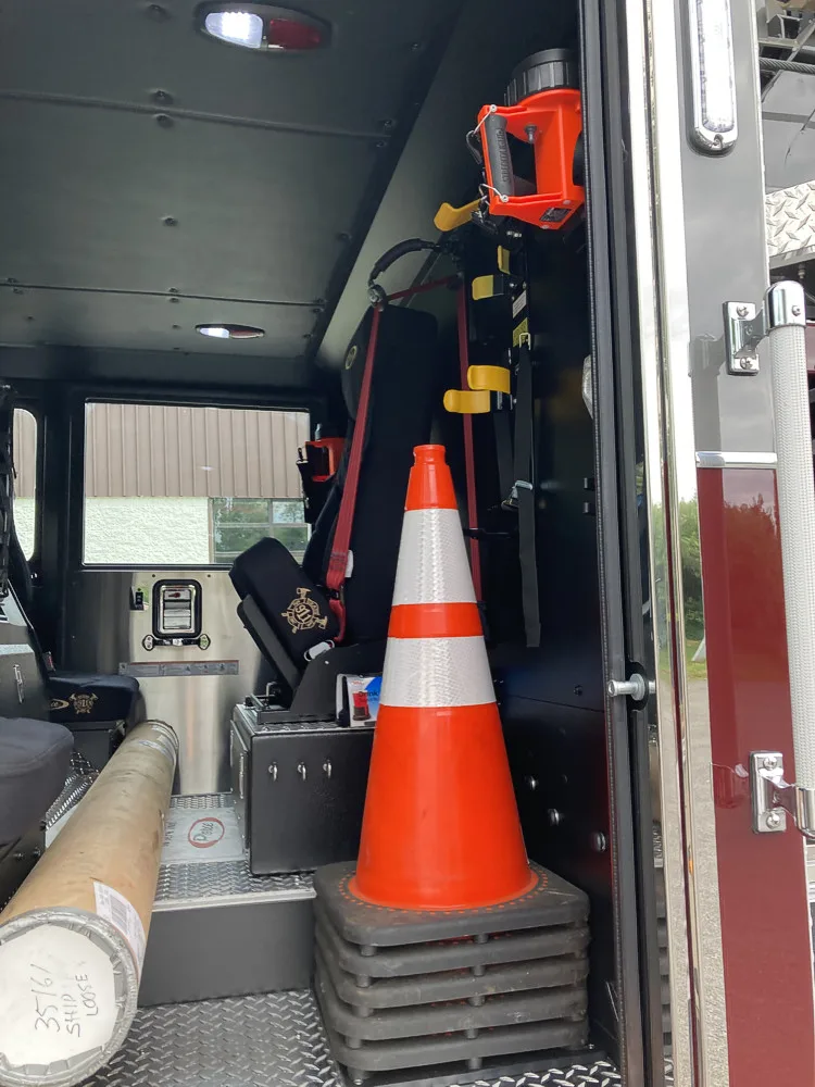 Rear crew interior close-up showing cone, seat area, and side storage