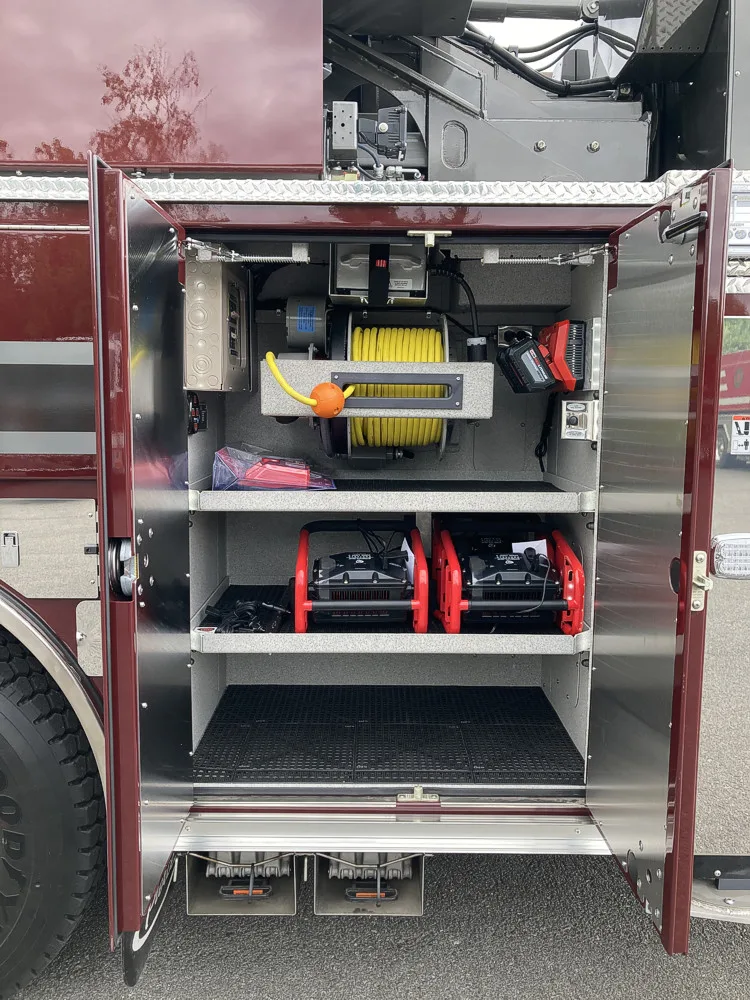 Open side compartment showing shelves with tool cases and storage bins