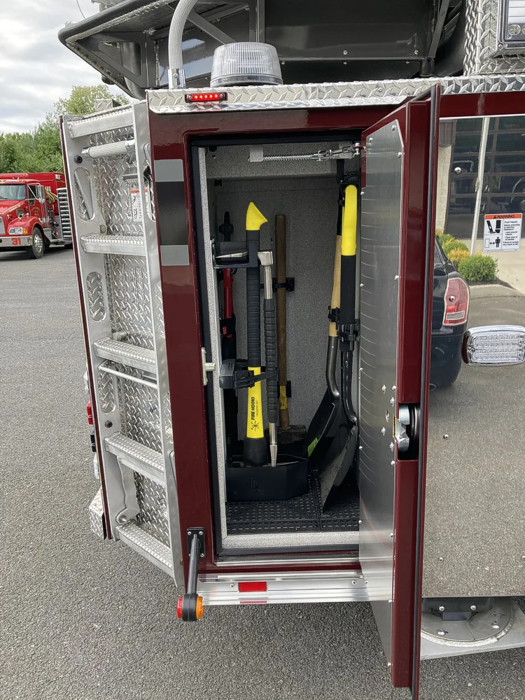 Open narrow side compartment showing long-tool rack and mounts