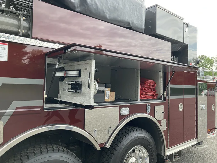 Side-body close-up showing equipment compartments and upper storage tray