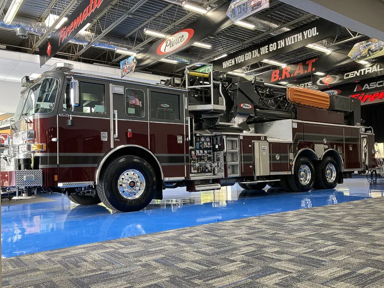 Tower ladder truck front-left profile in apparatus bay