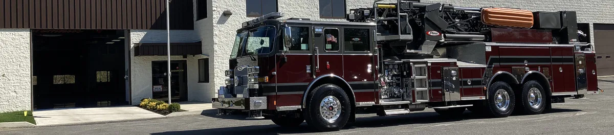Driver-side profile strip view showing full ladder truck body