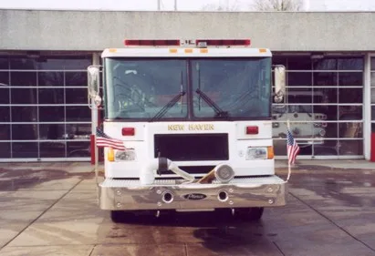 Head-on front view showing windshield, warning lights, front intake ports, and chrome bumper.