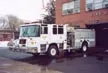 Wide front right view of the parked pumper showing full cab and side body.
