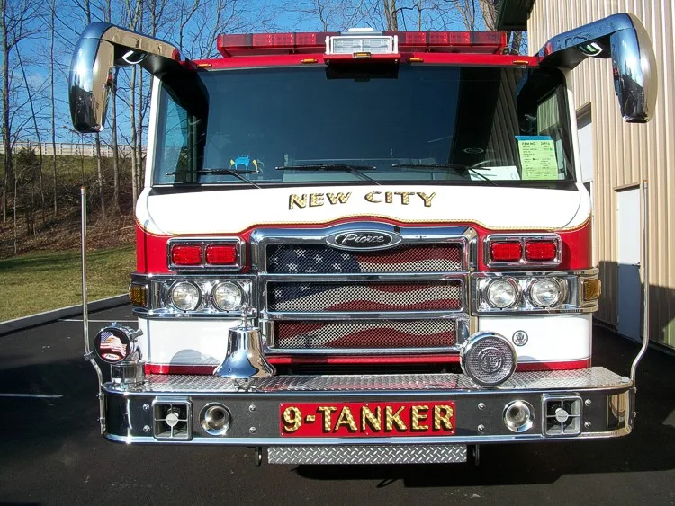 Head-on front close-up showing grille, windshield, warning lights, and front bumper fittings.