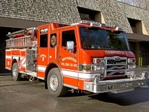 Front-left exterior view showing cab, bumper, and side compartments