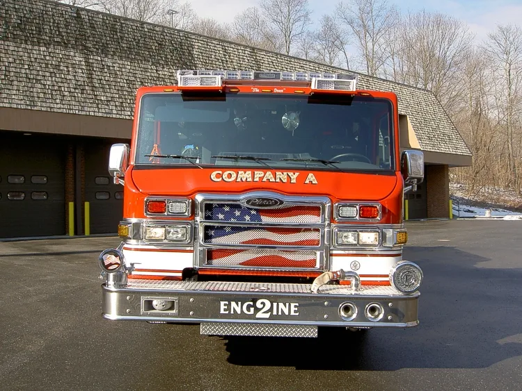 Front exterior view showing grille, bumper, and warning lights
