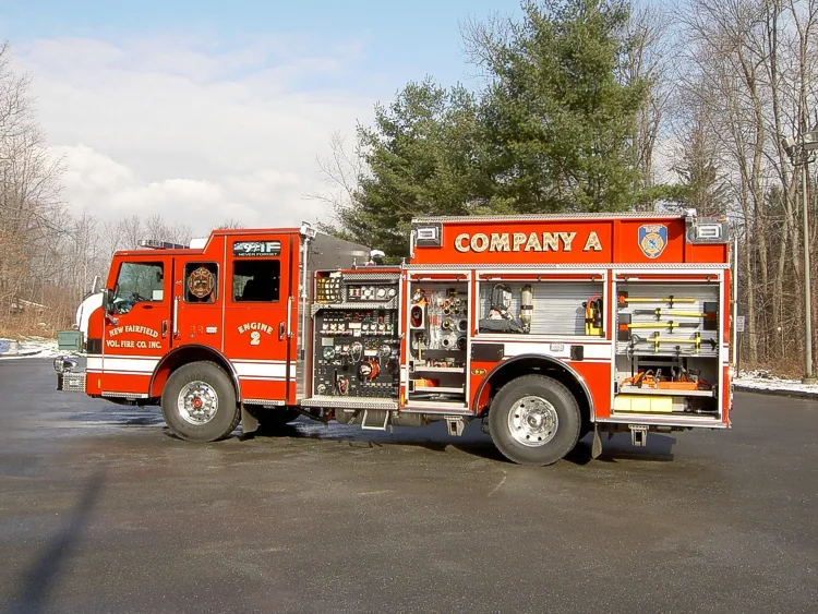 Passenger-side profile with open compartments showing tools and storage shelves