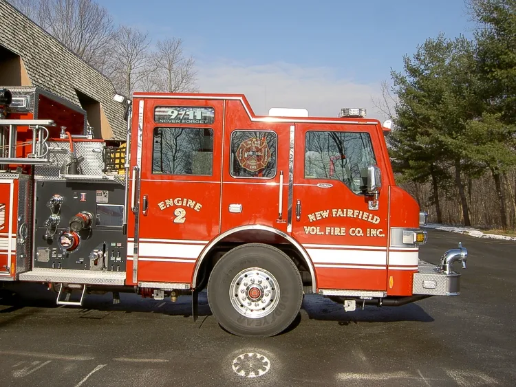 Driver-side profile view showing pump panel area and side compartments