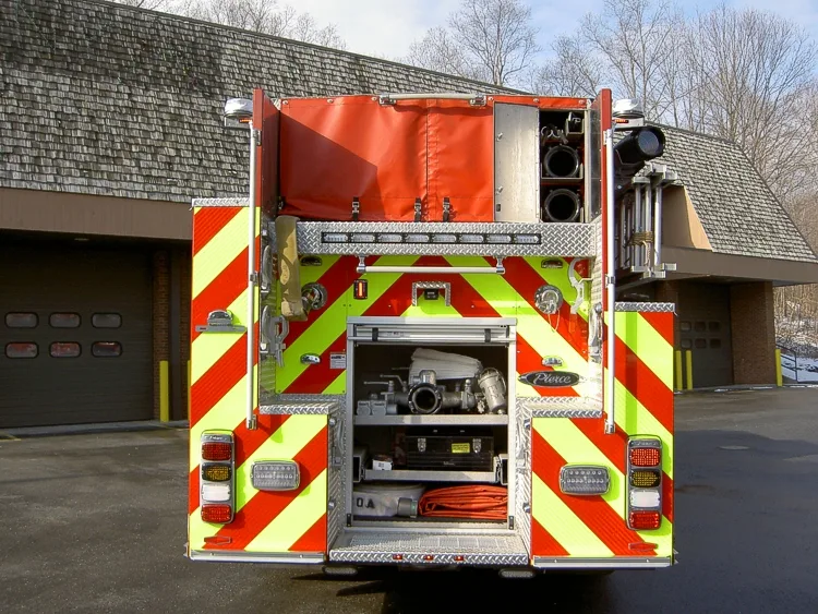 Rear view showing open hosebed, rear compartment, and chevron striping