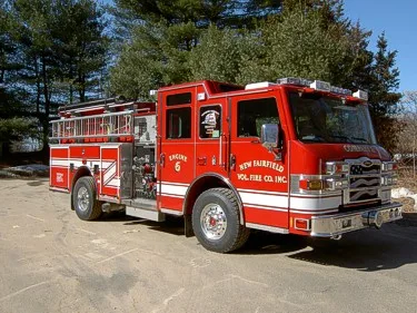 Front-right exterior view showing cab and side compartments