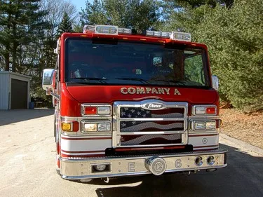 Front exterior view showing grille, bumper, and warning lights