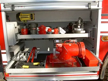 Open compartment close-up showing pump equipment and fittings on shelves