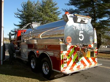 Rear-left exterior view showing polished tank body and rear light cluster