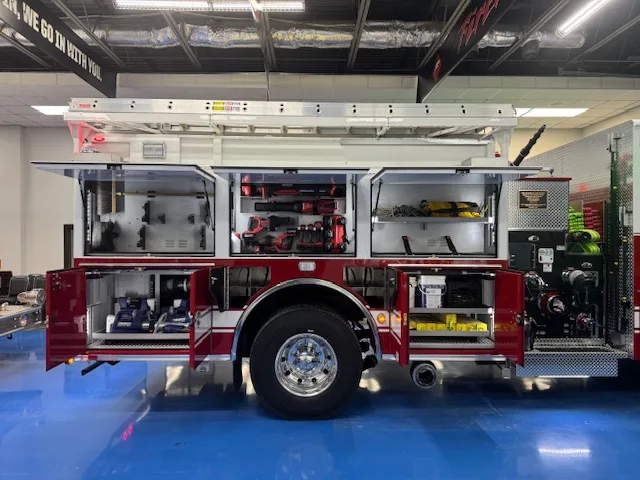 Driver-side profile with open compartments showing storage shelves and equipment