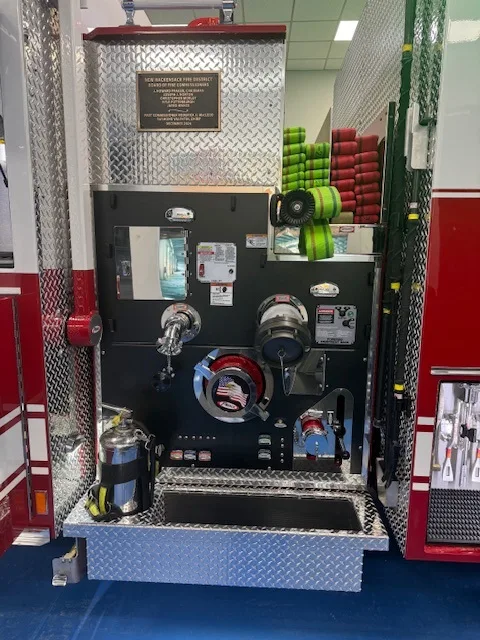 Pump panel close-up showing gauges, valves, and hose connections