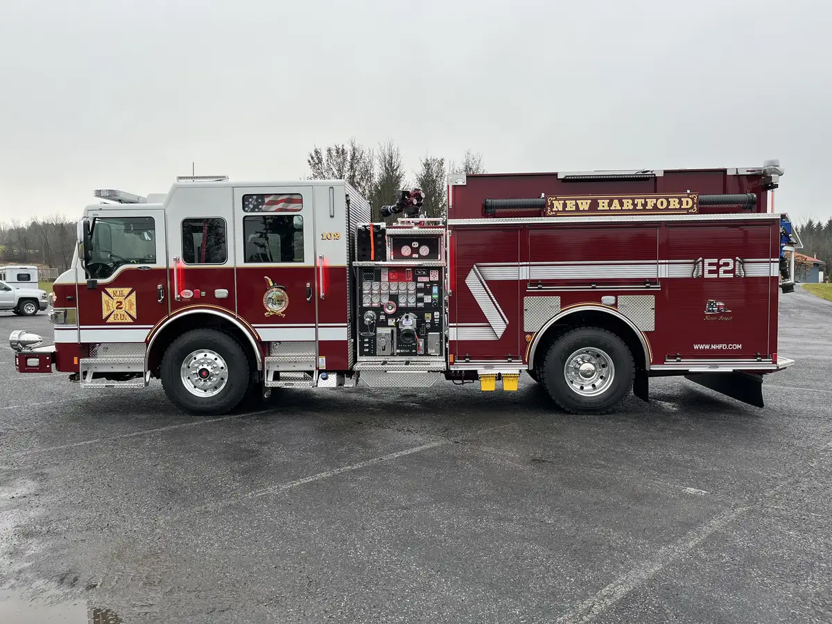 Driver-side profile view with closed compartment doors and exposed pump panel