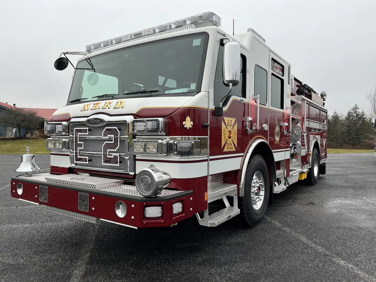 Front-right exterior close view showing grille, bumper, and warning lights