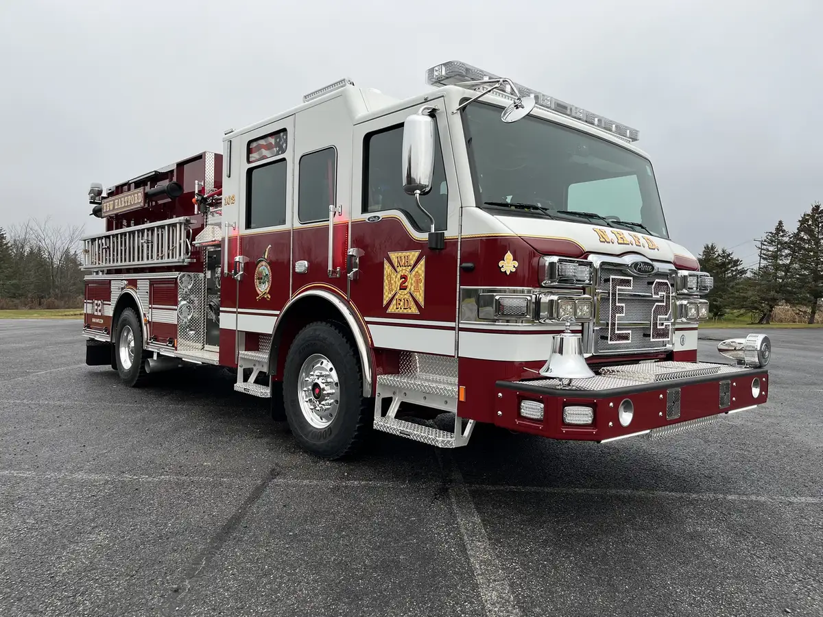 Pumper front-right exterior view showing crew cab, side compartments, and front wheel