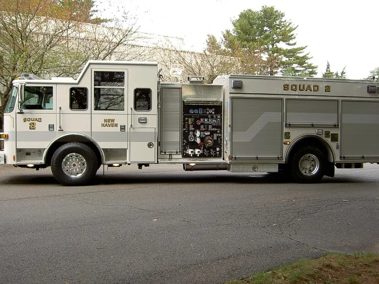 Driver-side profile with open pump panel showing gauges and controls