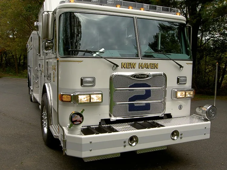 Front-right exterior close view showing grille, bumper, and cab corner