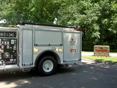 Right-side rear body close-up showing roll-up compartment door, rear wheel, and side marker lights.