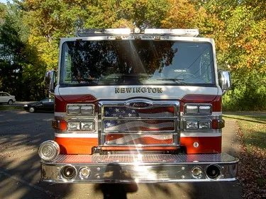 Front exterior view showing grille, bumper, and warning lights