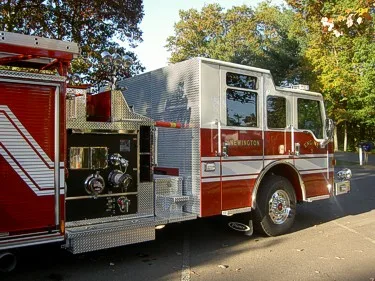 Rear-right view showing pump panel area, side compartments, and rear wheel