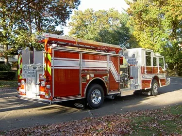 Rear-right exterior view showing side hosebed rails and rear body
