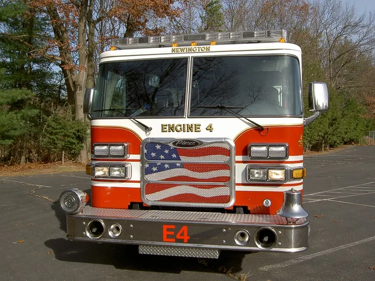 Head-on front view showing windshield, grille, warning lights, and front intake ports.