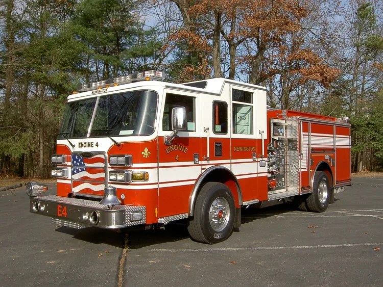Front left side view showing cab doors, pump panel controls, and side roll-up compartment doors.