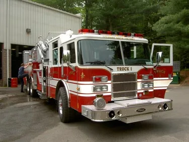 Front right close view showing chrome bumper, grille, windshield lights, and cab door area.