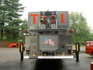 Straight rear view showing rear stabilizers, rear door panel, and bucket waterway connections.