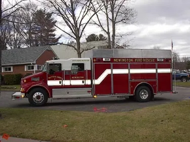 Full right-side profile showing long box compartments, roof-mounted light area, and rear wheel section.