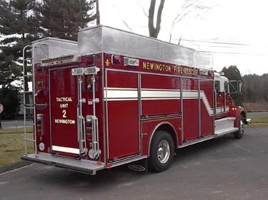 Rear left angle showing rear compartment doors, corner lighting, and body side access panels.