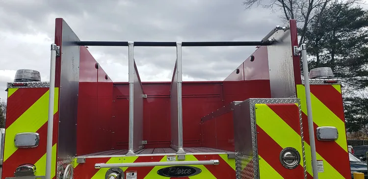 Rear view close-up showing hosebed opening above chevron panel