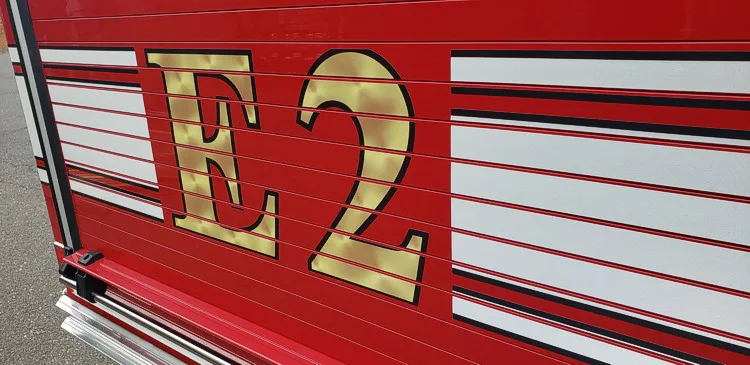 Body side close-up showing large unit numeral and striping