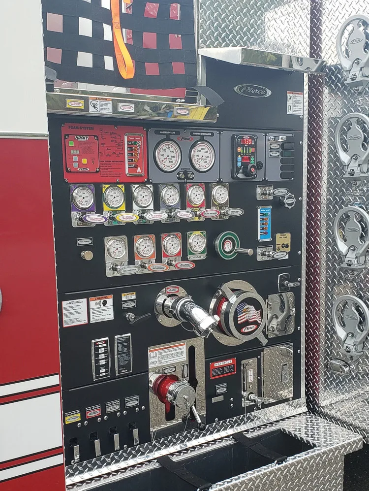 Pump panel close-up showing gauges, valves, and intake controls