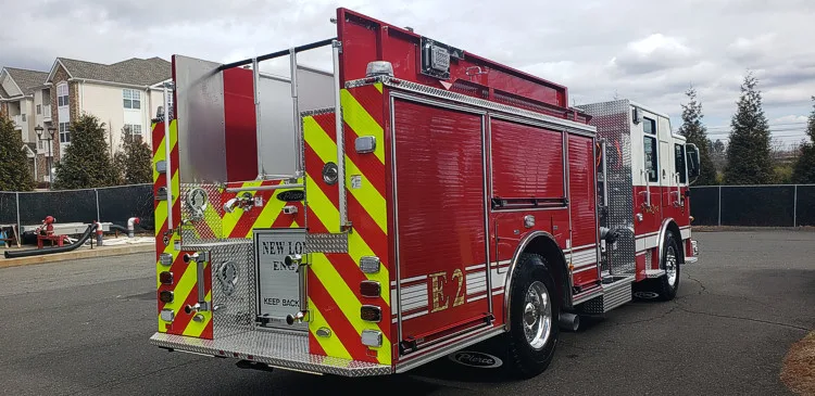 Rear-right exterior view showing side compartments and rear warning lights