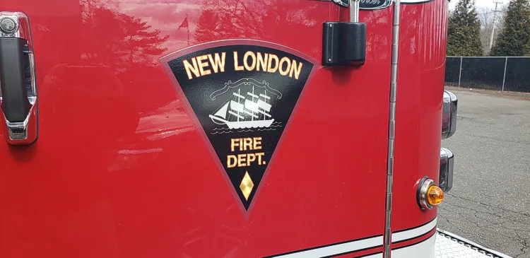 Cab door close-up showing shield-style department patch on red panel