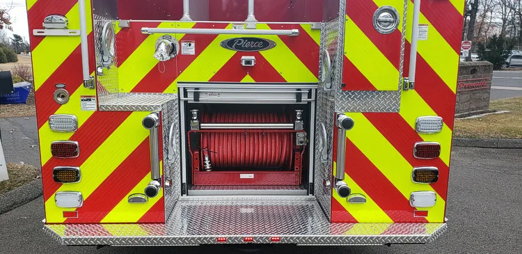 Rear view showing chevron striping and center rear compartment opening