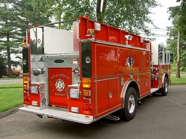 Rear-right exterior view showing rear panel, side compartments, and hosebed area