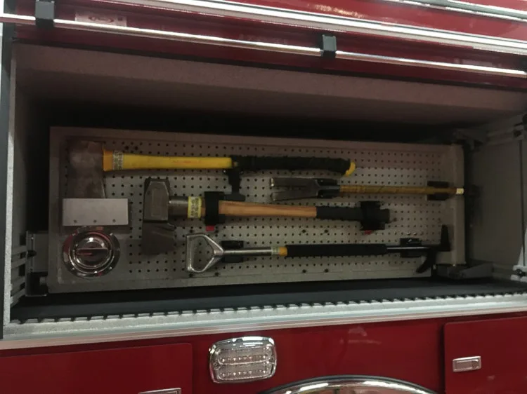 Open side compartment close-up showing hand tools and mounting brackets